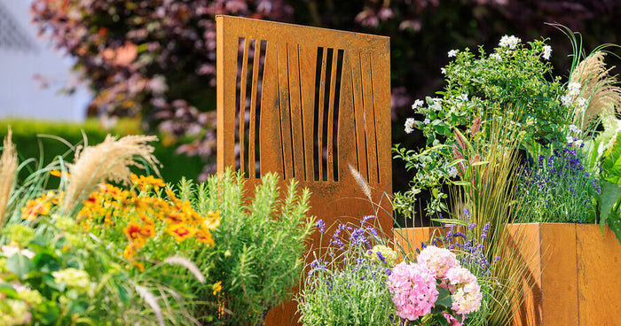 Corten steel in a natural garden: harmony of rust and wilderness
